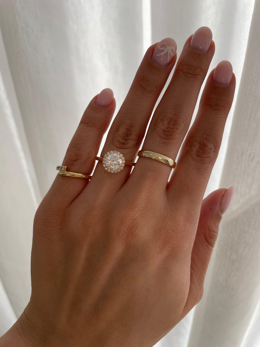 a woman's hand with two rings on it
