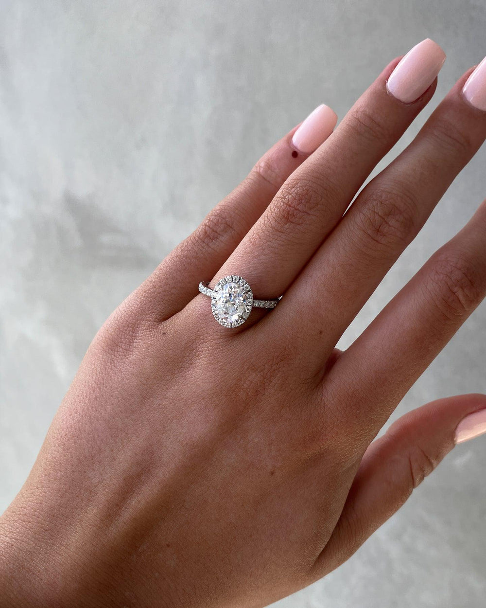 a woman's hand with a diamond ring on it