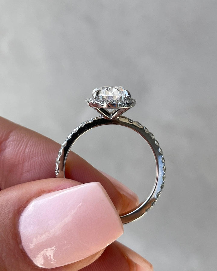 a close up of a person holding a ring
