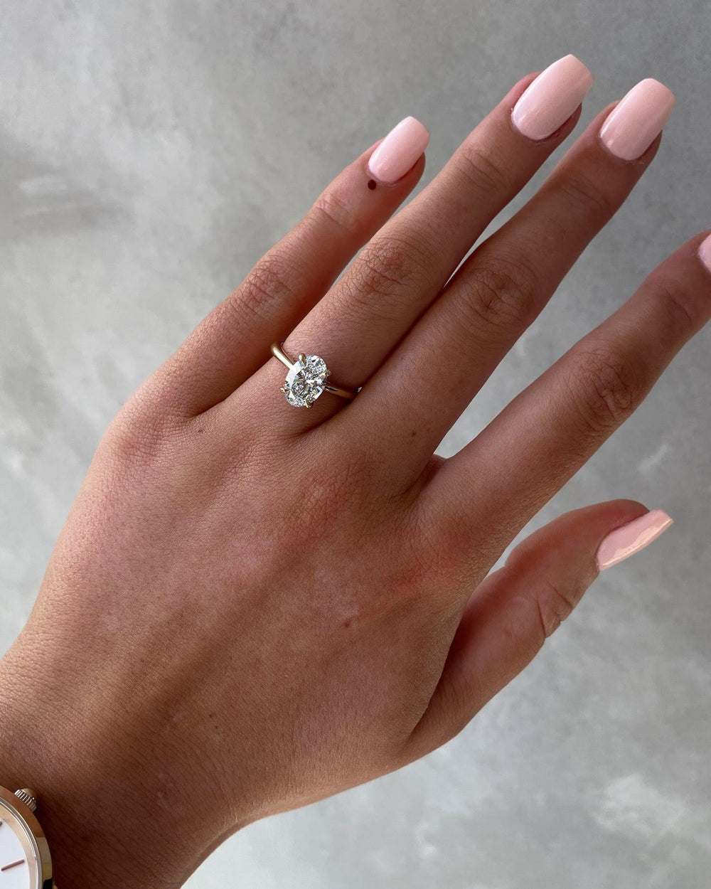 a woman's hand with a diamond ring on it