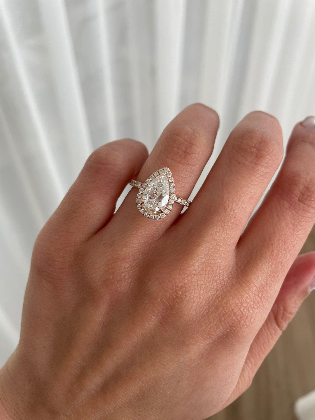 a woman's hand with a diamond ring on it