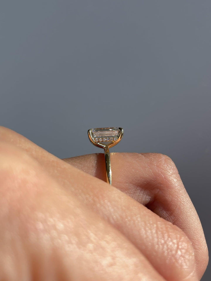 a close up of a person's hand holding a ring