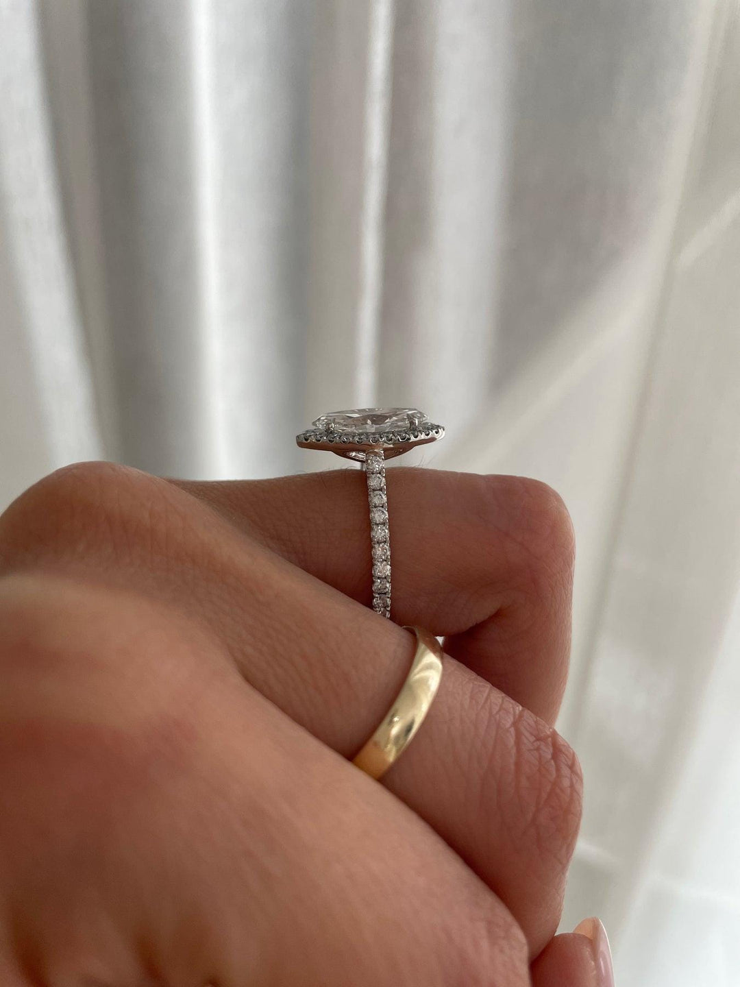 a person holding a diamond ring in their hand
