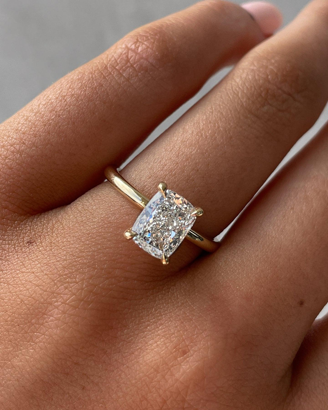 a close up of a person's hand with a ring on it