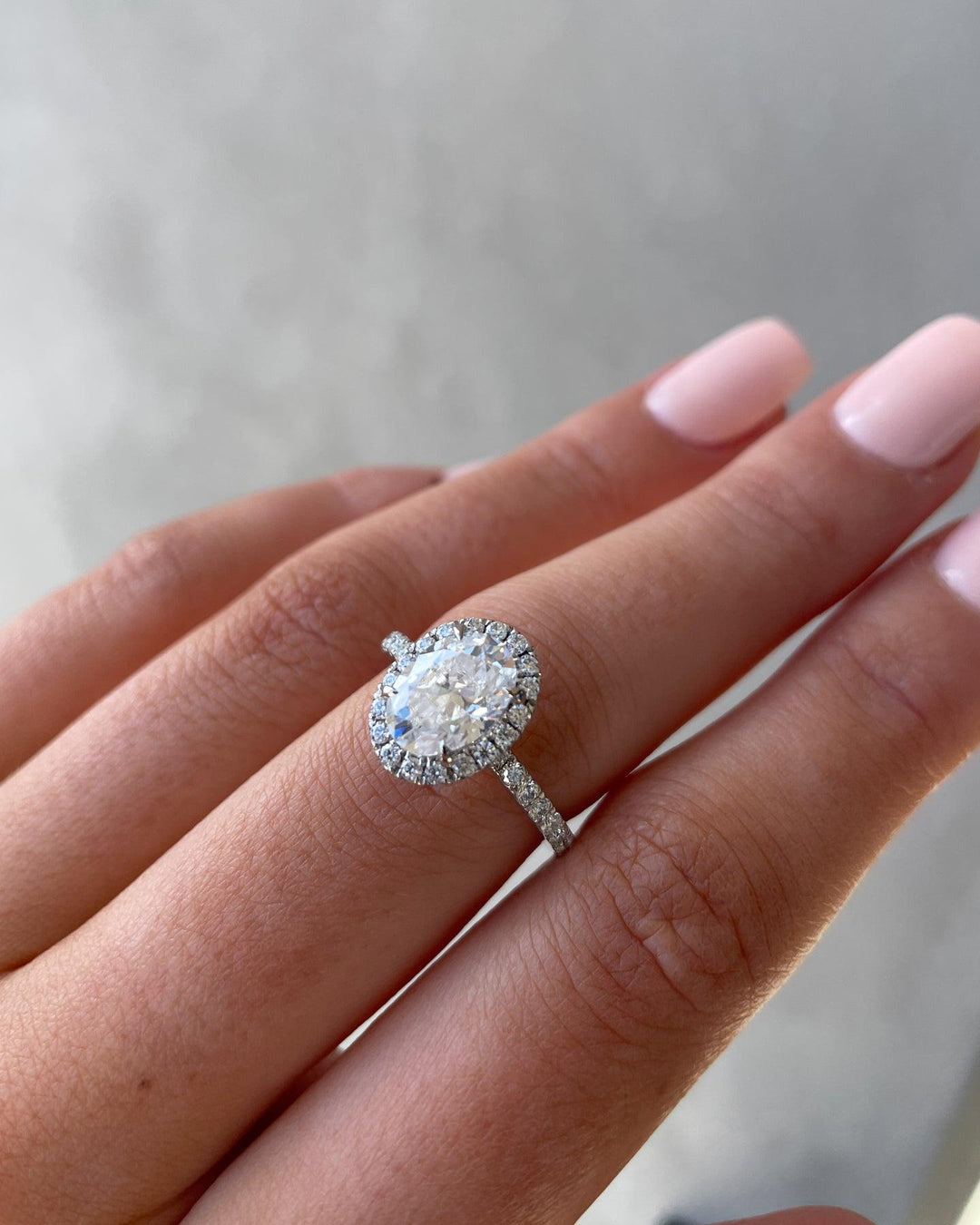 a woman's hand with a diamond ring on it