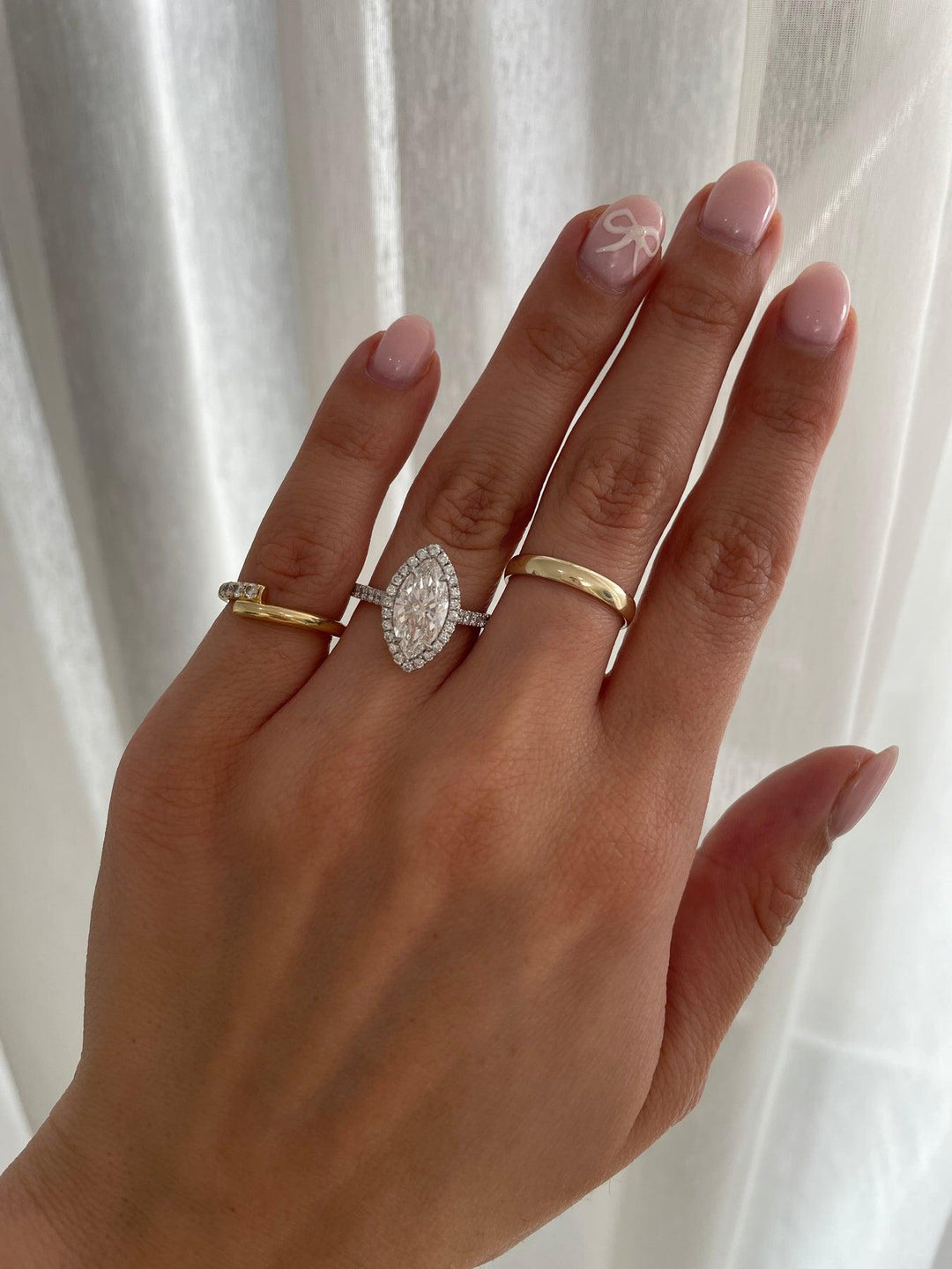 a woman's hand with two rings on it