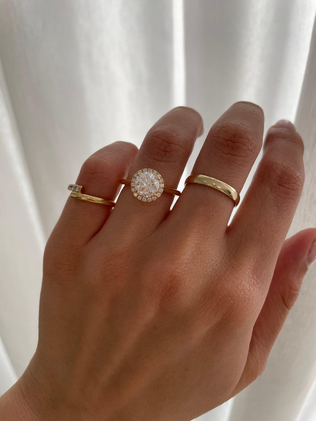 a woman's hand with two rings on it