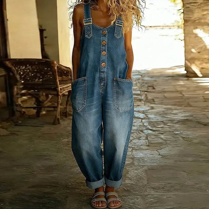 Dame i blå overalls i denim look med store forlommer og oprullede ben