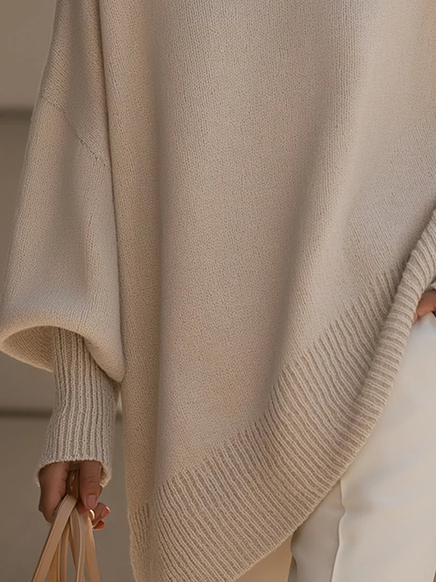 Detalje af ribstrikket manchet og asymmetrisk bundkant på strikbluse