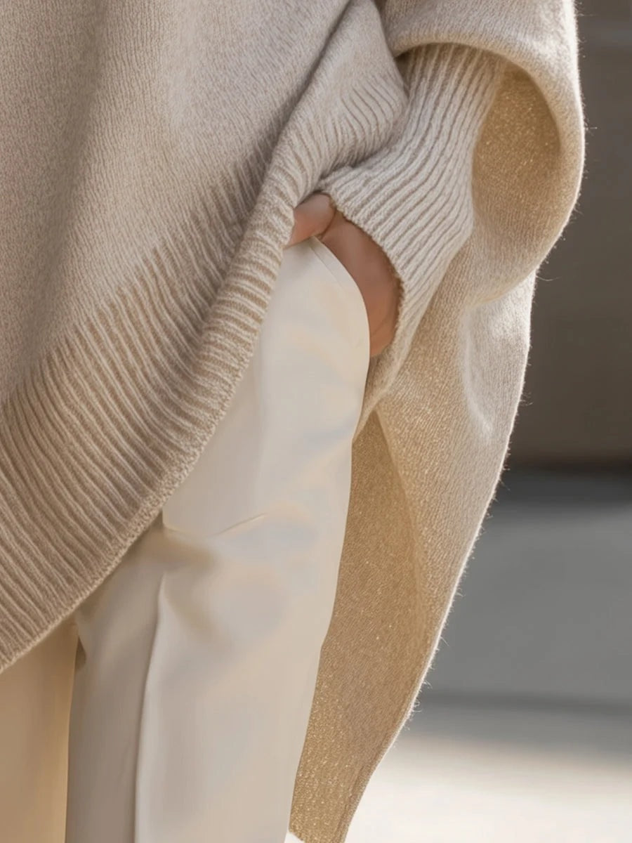 Oversized strikbluse dame med flagermusærmer og asymmetrisk kant