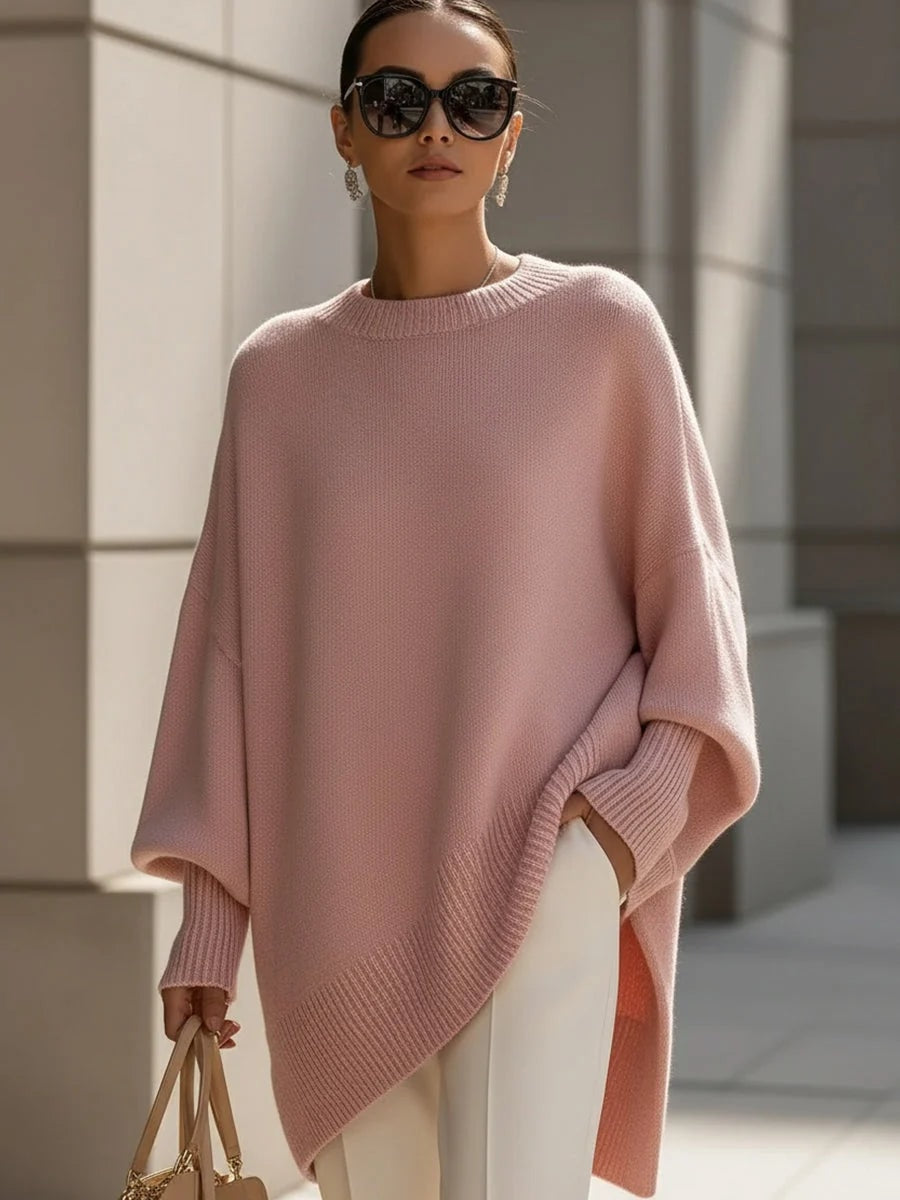 Oversized strikbluse dame med flagermusærmer og asymmetrisk kant