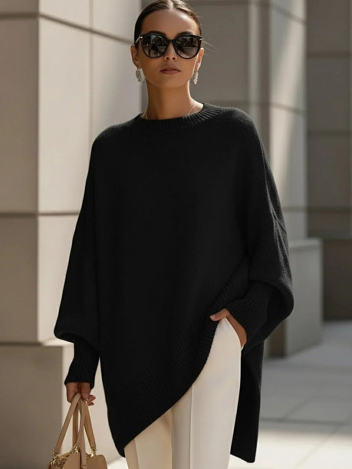 Oversized strikbluse dame med flagermusærmer og asymmetrisk kant