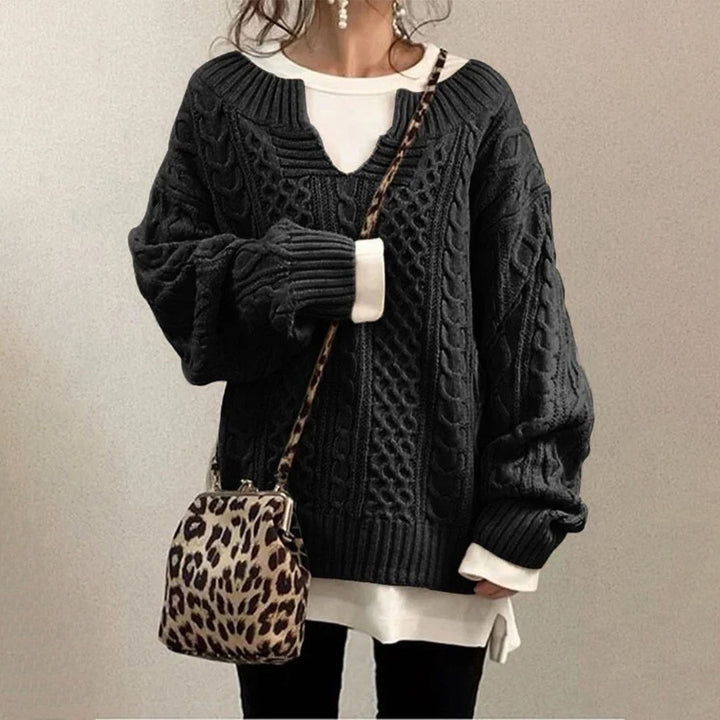 Sort oversized strikbluse til damer med v hals og snoninger
